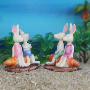Detailed shot of cute little rabbit carrot resin figurines miniature succulent landscape sand accessories.