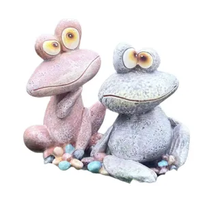Cute quirky frog resin figurine ornaments for indoor outdoor garden decor, pair set on pebbles.