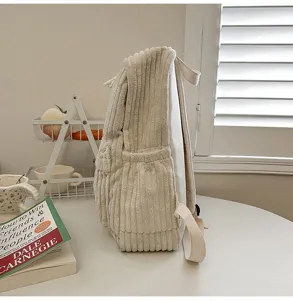 Side view detail of solid beige corduroy backpack for women, casual school bag, large capacity.