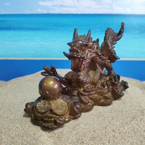 Detailed view of traditional Chinese dragon tea pet figurine with lucky coins and pearl decor.