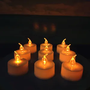 Close-up detail of warm yellow LED tea light candles, creating cozy ambient lighting for parties.