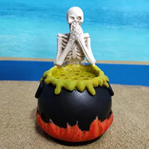 Detailed close-up of the Halloween skeleton resin cauldron ornament, showcasing spooky skull decor.
