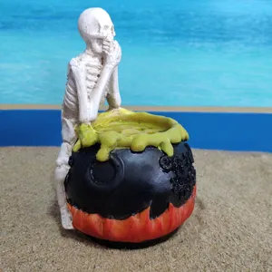Detailed close-up view of the resin Halloween skeleton sitting on a witch cauldron decor.