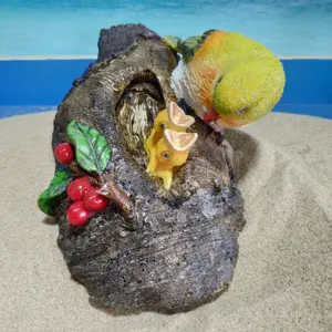 Resin parrot feeding chicks tree stump ornament detail shot, perfect for garden decor.