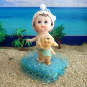 Resin baby doll with puppy figurine detail view, sandplay therapy toy desktop display.