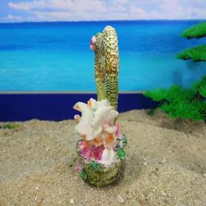 Detailed close-up view of resin dove and flower basket craft ornament for sand tray toys.