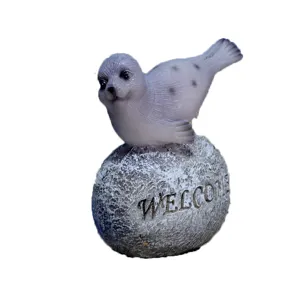Resin seal animal figurine detail shot, cute ocean creature ornament with carved rock base.