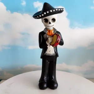 Skeleton figurine playing tambourine wearing sombrero, perfect for Halloween and Day of the Dead decor.
