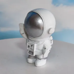 Detailed view of white astronaut figurine ornament with silver visor and space suit design.
