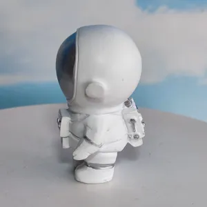 Close-up side view of white astronaut figurine, cute resin desktop ornament for home.