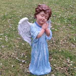 Detailed view of a resin angel garden statue, praying pose with white wings, perfect for yard.