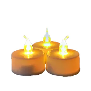 Close up of three glowing LED tea light candles with warm yellow light for romantic decoration.