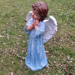Resin praying angel garden statue with white wings and blue robe for outdoor yard decor.