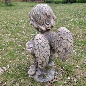Detailed view of resin angel bird feeder statue, vintage stone texture garden ornament back.