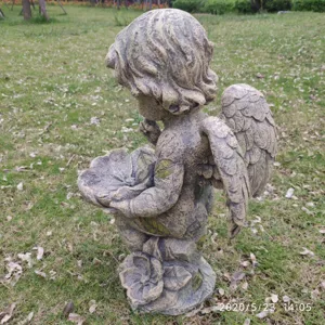 Garden angel statue bird feeder detail shot, resin outdoor courtyard lawn ornament decor.