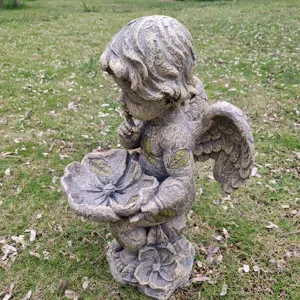 Resin angel garden statue bird feeder, vintage outdoor sculpture for lawn and yard decor.