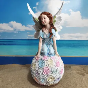 Detailed shot of resin angel flower fairy figurine with colorful roses base for garden decor