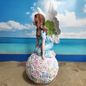 Exquisite angel fairy resin figurine sitting on a rose sphere, perfect for garden and yard decor.