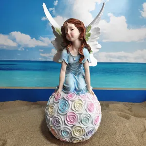 Resin angel fairy figurine detail showing delicate wings and colorful rose ball base decor.