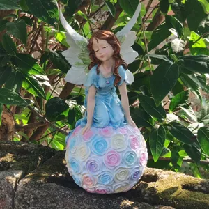 Garden resin angel fairy figurine with pastel rose flower ball, outdoor decorative sculpture.