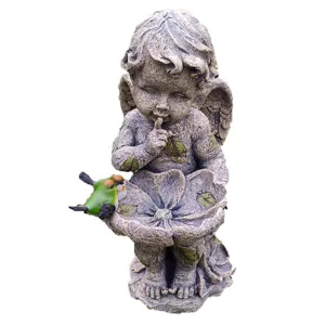 Detailed view of the resin angel garden statue featuring a bird feeder and cute small birds.