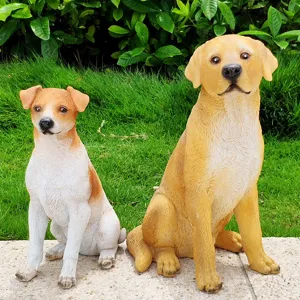 Detailed view of outdoor garden dog statues featuring realistic resin puppy and labrador decor figures.