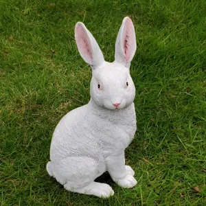Detailed view of white rabbit garden statue, cute animal figurine for outdoor yard decor.