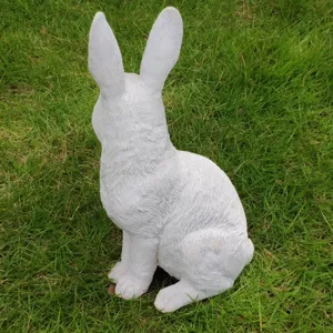 White rabbit garden statue detail, outdoor lawn animal ornament sculpture for yard decor.