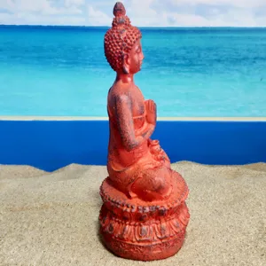 Detailed close-up of Thai Shakyamuni Buddha resin statue ornament, vintage red finish.