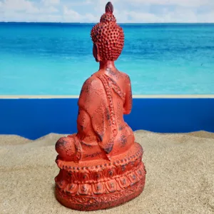 Resin Buddha figurine detail view, antique red finish, decorative sculpture background.
