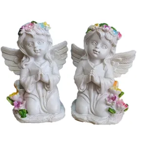 Vue détaillée de statues d'anges agenouillés, figurine en résine avec couronne de fleurs.