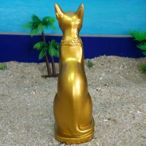 Golden Egyptian cat Bastet resin figurine detail view, vintage artifact ornament.