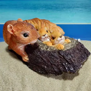 Detailed resin squirrel family figurine with mother and babies inside a realistic trunk.