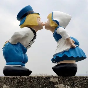 Garden couple kissing statue detail, retro style resin ornament for yard decor.