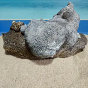 Resin koala figurine detail shot, featuring realistic fur texture and a natural tree base.