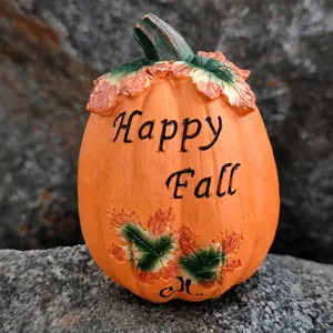 Resin pumpkin figurine detail shot, close-up view of autumn harvest holiday home decor.