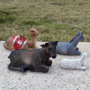Detailed view of resin animal figurines including camel, ox, donkey, and sheep for display.