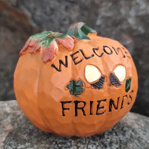 Pumpkin resin ornament detail featuring carved welcome friends text and autumn harvest design.