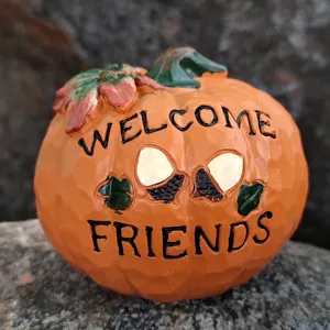 Halloween harvest pumpkin resin decoration ornament detail view, autumn holiday tabletop display.