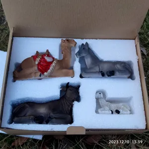 Resin Nativity animal figurines set including camel donkey ox and lamb religious decor.