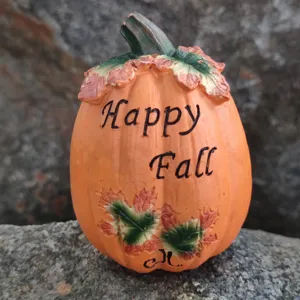 Resin pumpkin decoration detail shot, autumn harvest theme ornament with English text.