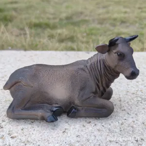 Detailed view of resin lying cow figurine ornament, realistic texture and pastoral display scene.