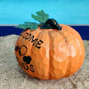 Resin pumpkin decoration with leaves and welcome friends text for Halloween and autumn harvest.