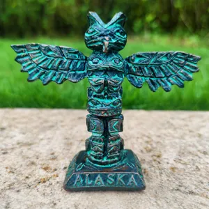 Close-up of the vintage resin totem owl figurine with carved details, textured bronze finish.