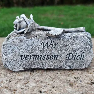 Memorial grave stone detail showing carved rose flower and German text. Perfect tribute item.