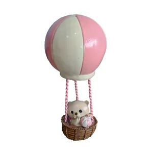 Detailed view of miniature hot air balloon bear toy for sand tray play and decor.