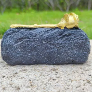 Resin memorial tombstone prop with gold rose detail, ideal for cemetery decor and Halloween.