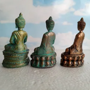 Detailed view of three Buddha statues meditation decor resin figures miniature props.