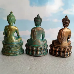 Detailed view of three Buddha statues for sandplay therapy, showing religious figurine back design.
