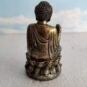 Close-up detail view of a miniature Buddha statue figurine seated on a lotus base for display.